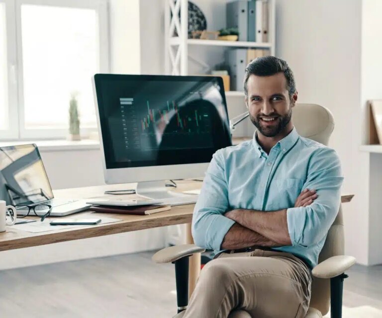 A man in the office smiling at the camera.