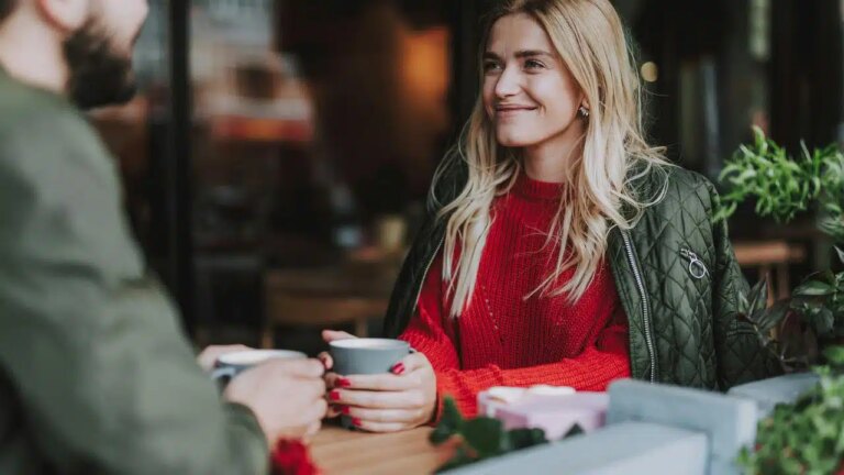 A woman smiling during a coffee date.